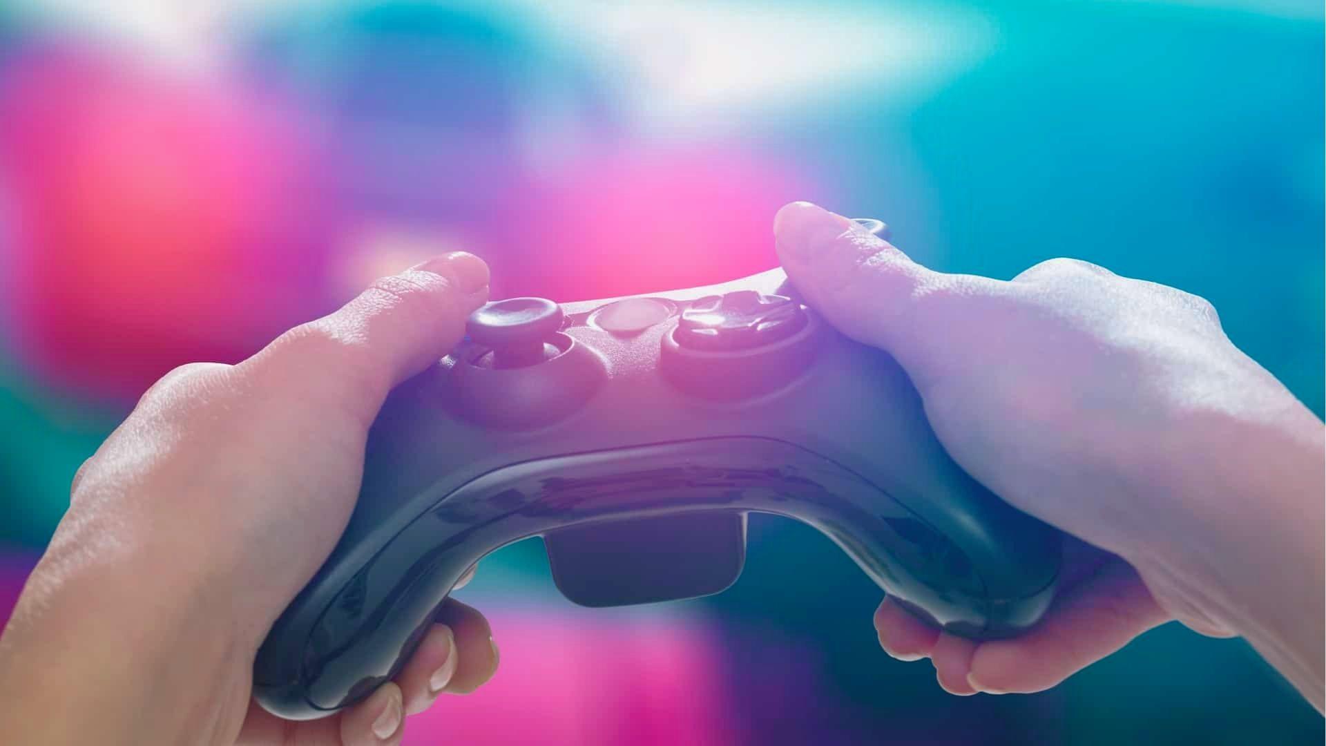 Close-up of two hands gripping a black video game controller during intense gameplay.