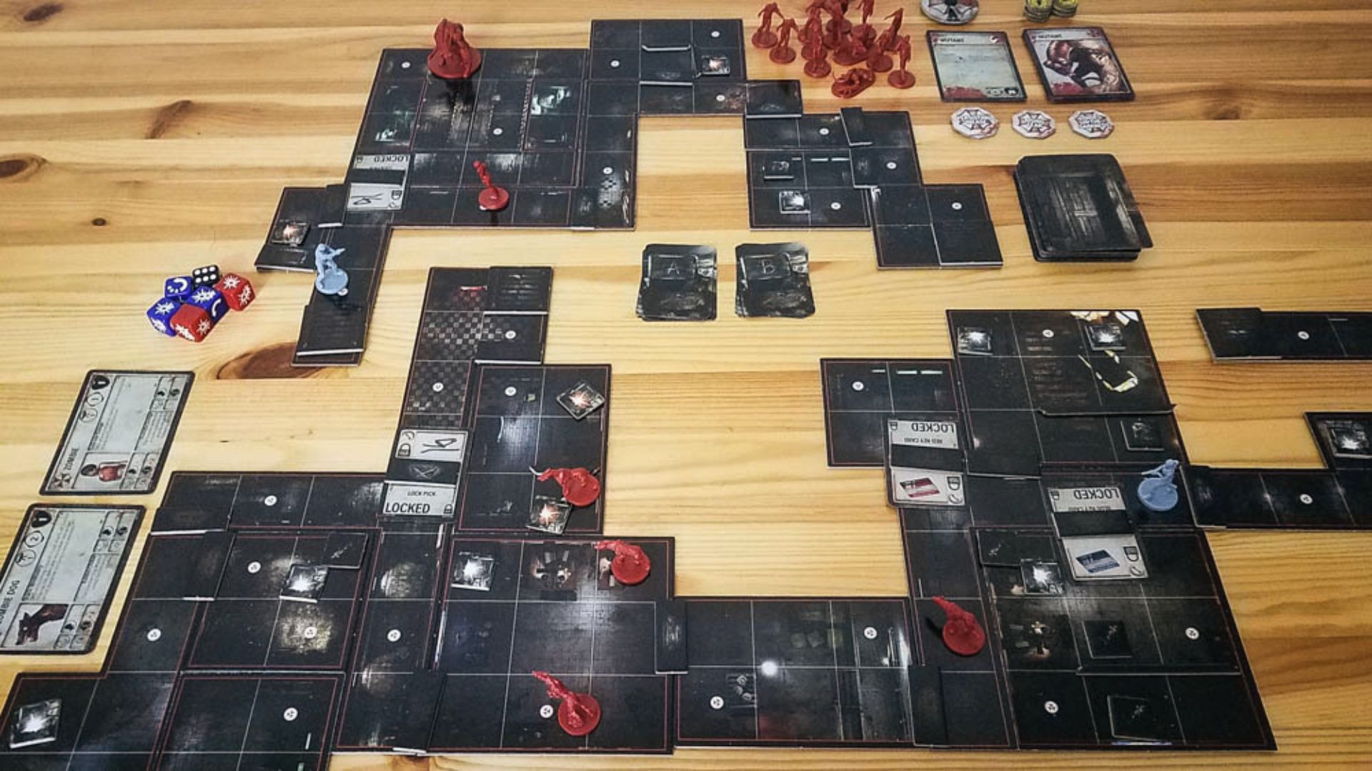 Sprawling RPD map tiles with zombie minis, locked doors, dice, and cards in Resident Evil 2 board game.