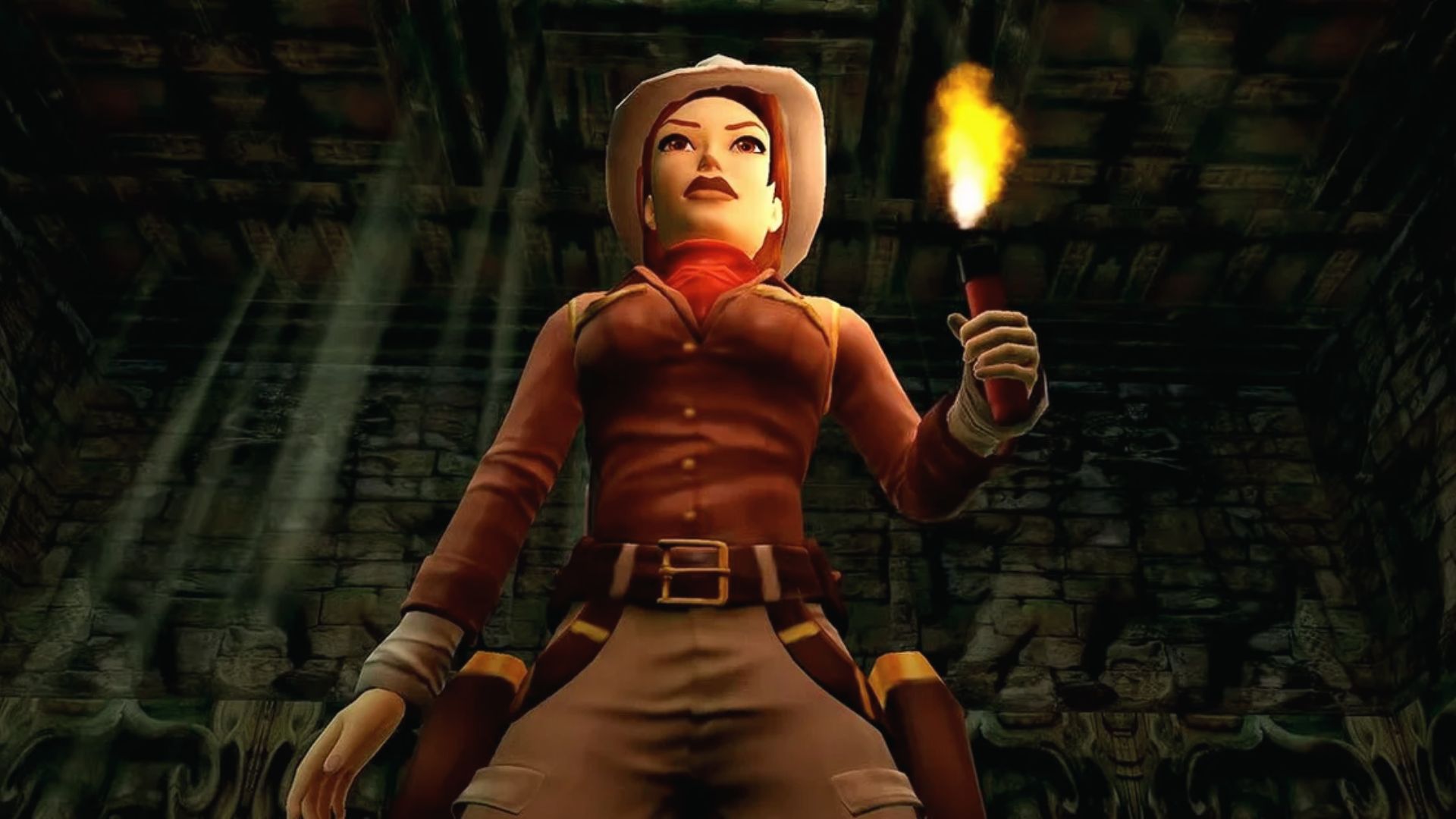 Cowgirl Lara holds a flaming torch underground, highlighting lighting upgrades on Switch remaster.