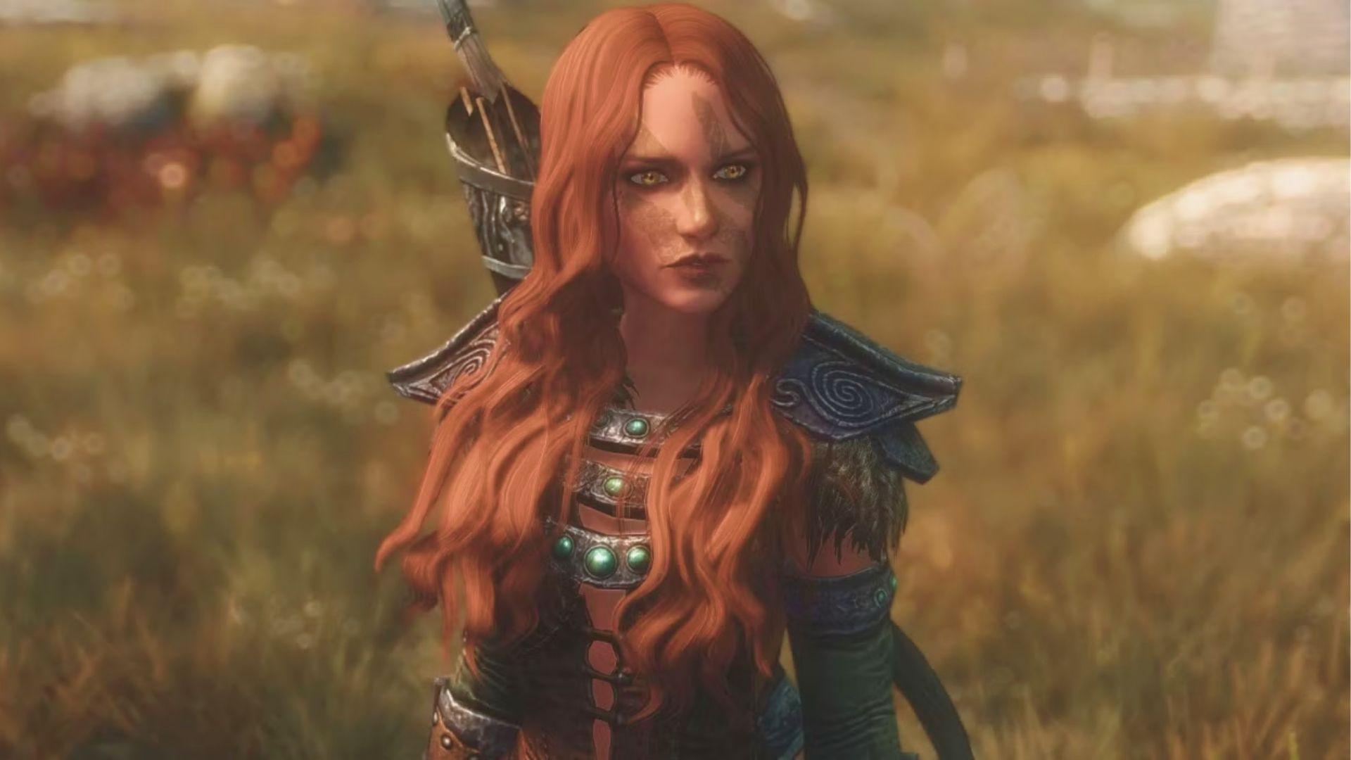 Red-haired Nord archer from Skyrim stands in a grassy field wearing ornate leather armor with green gems.