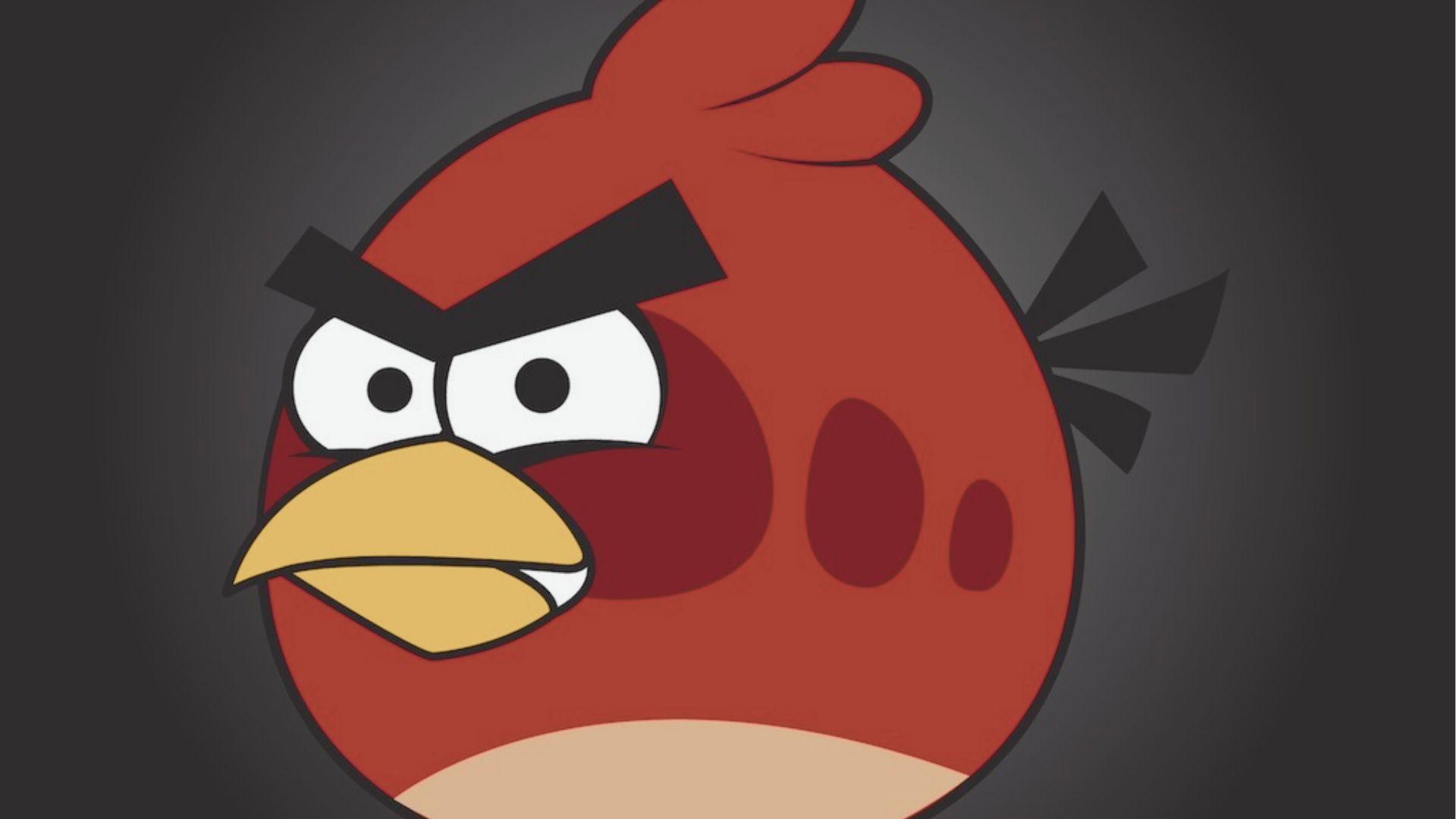 Close-up of Red, the round red bird leader from Angry Birds, glaring with thick black eyebrows.