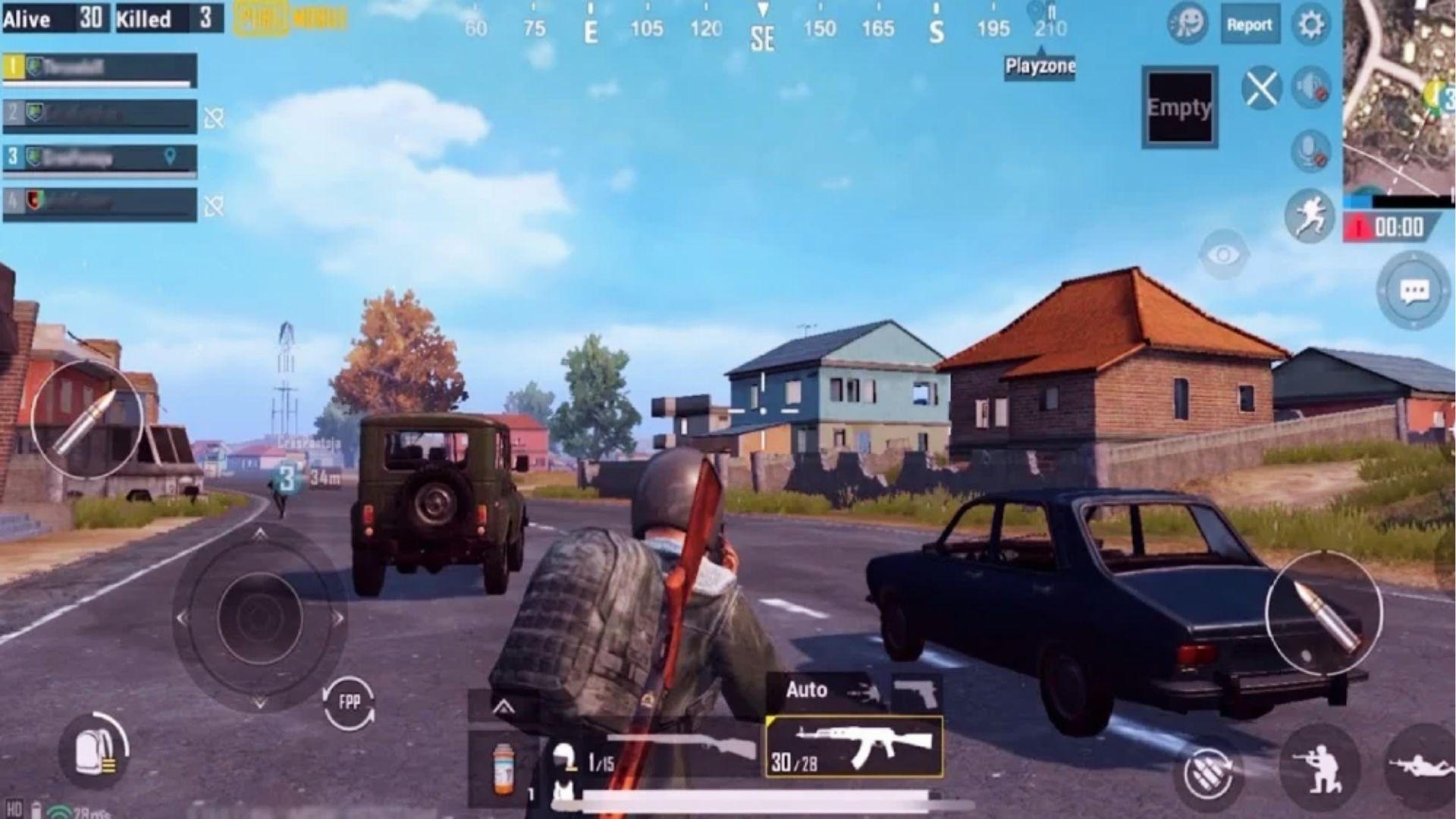 First-person PUBG Mobile gameplay view driving past cars and houses, showing mobile graphics and controls for PS5 crossplay comparison