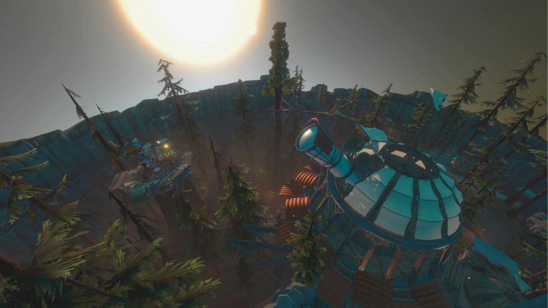 Aerial view of the Timber Hearth Observatory and launch tower nestled among tall pines at dawn.